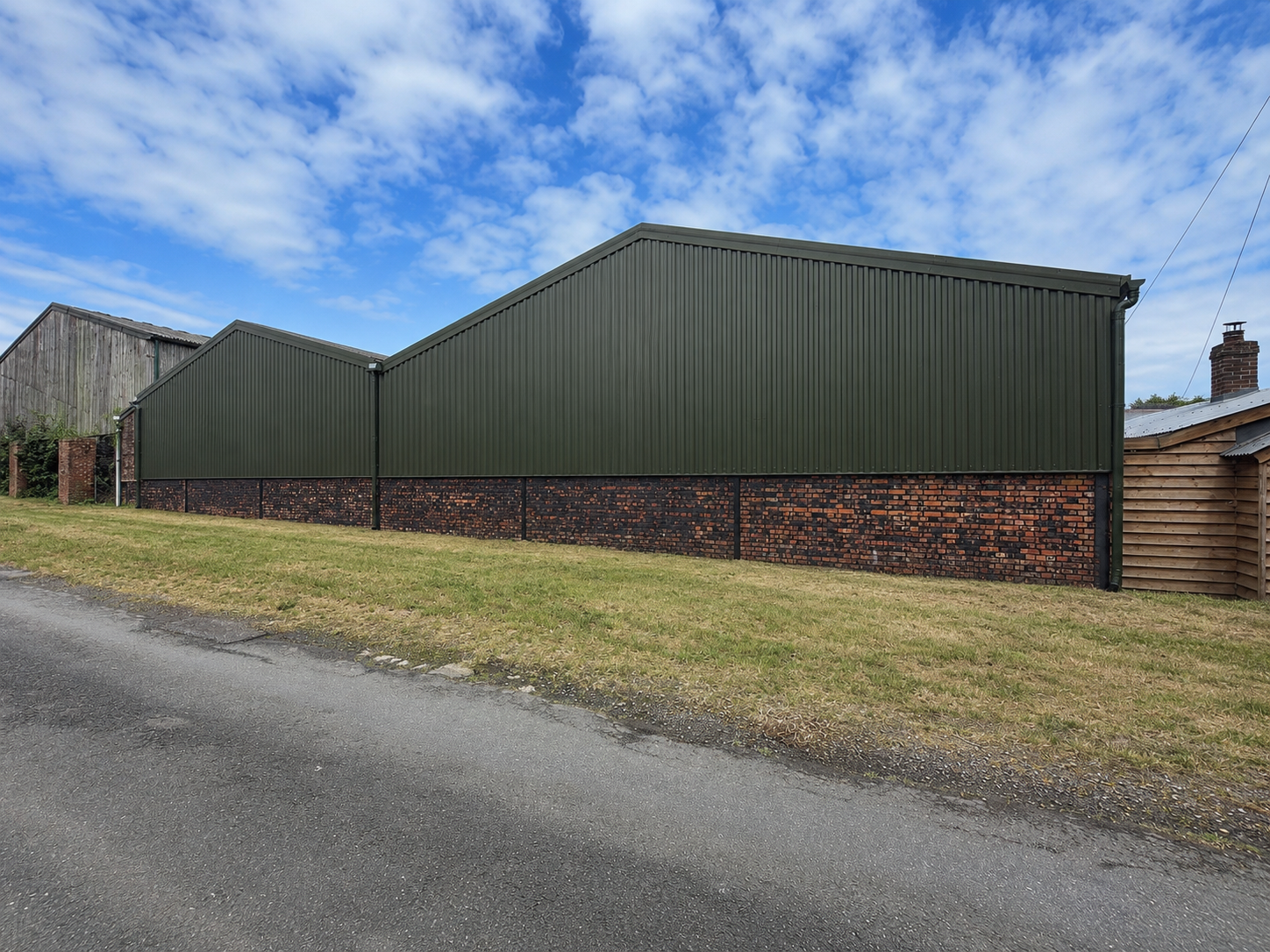 After olive green box profile barn cladding