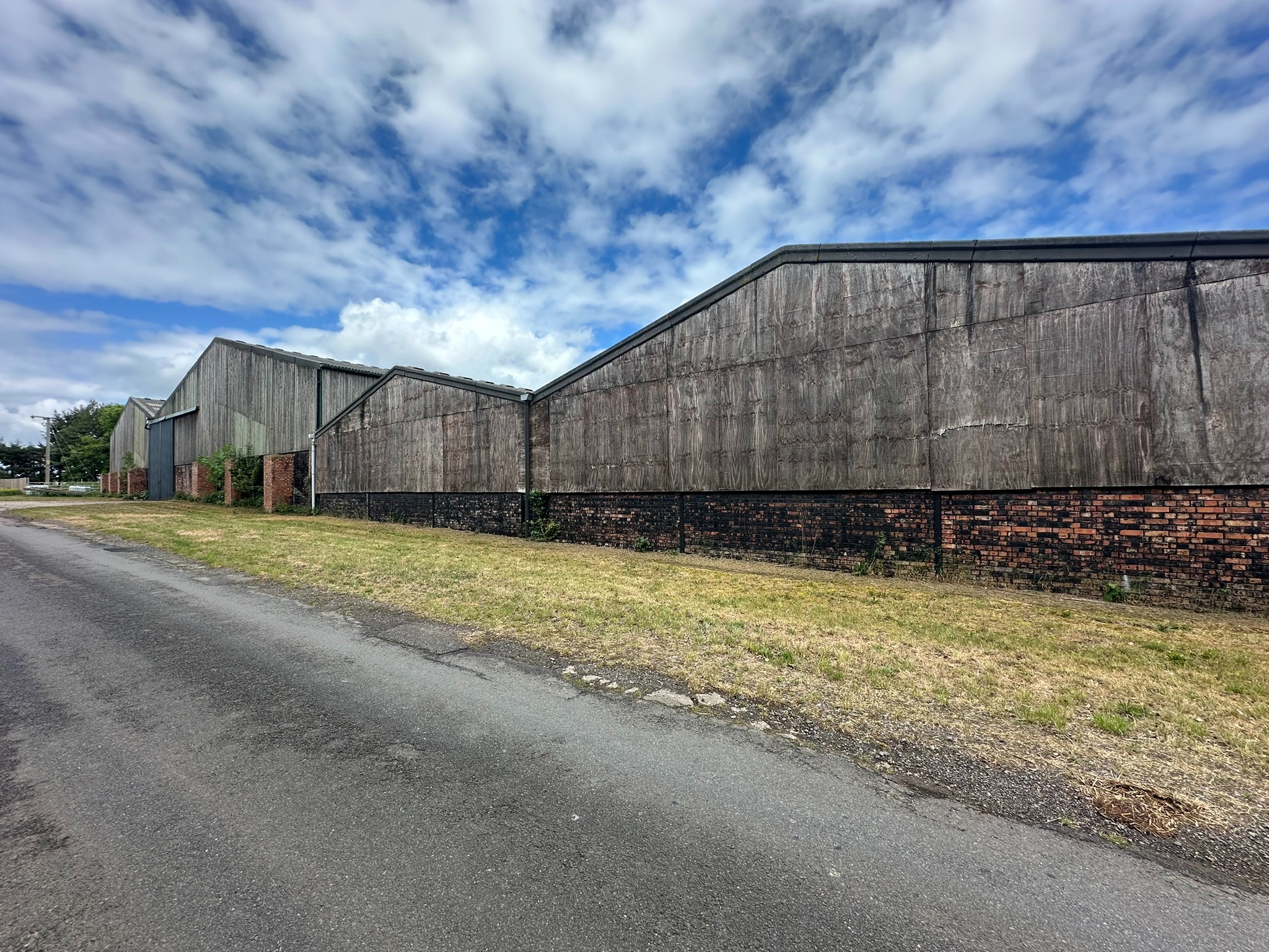 Weathered agricultural building before cladding work